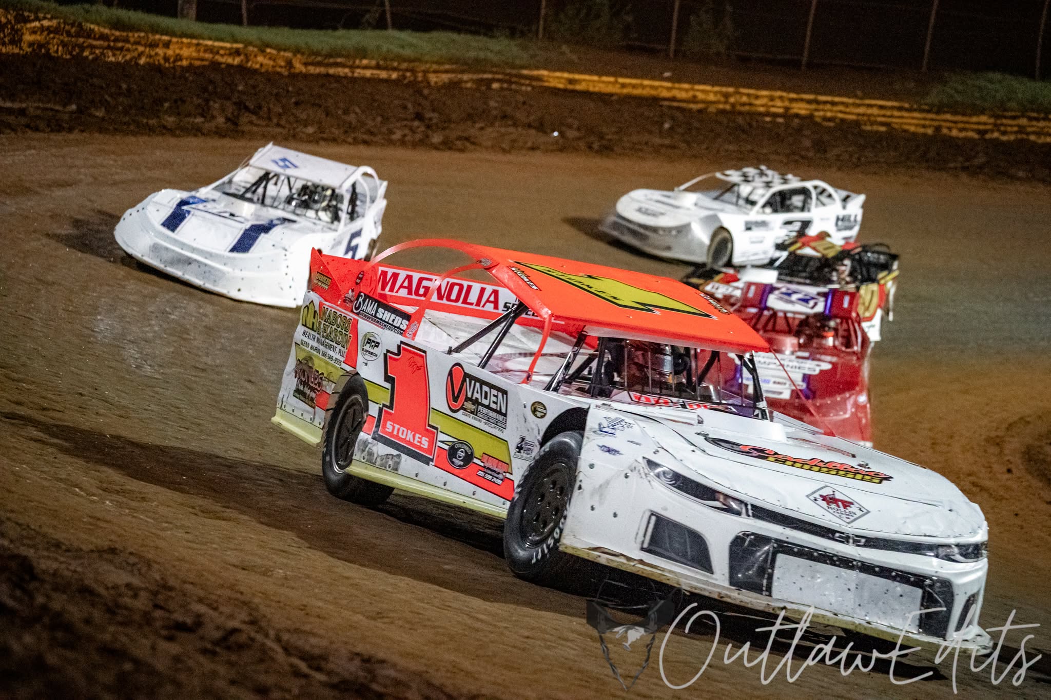 Street Stock race cars battling on a dirt oval